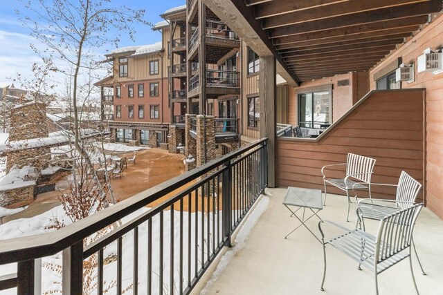 view of snow covered back of property
