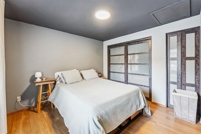344 Illinois Gulch Rd Unit 201, Breckenridge, CO 80424 - bedroom with light wood finished floors, baseboards, and attic access