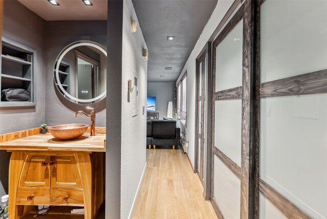 344 Illinois Gulch Rd Unit 201, Breckenridge, CO 80424 - corridor featuring a sink, light wood-style flooring, and a textured wall