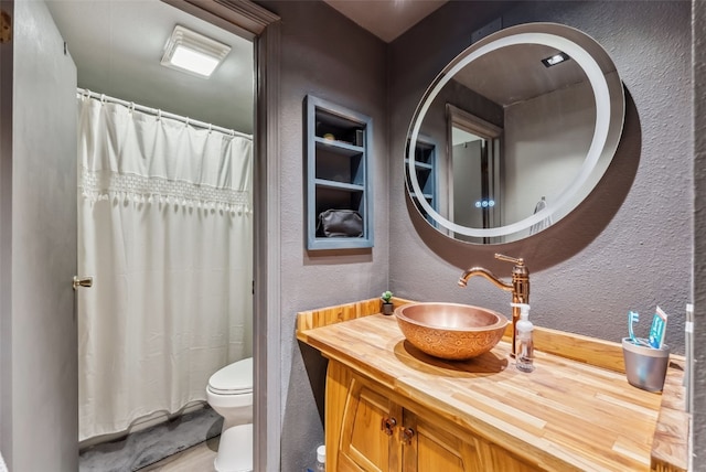 344 Illinois Gulch Rd Unit 201, Breckenridge, CO 80424 - bathroom featuring a textured wall, toilet, vanity, and a shower with shower curtain