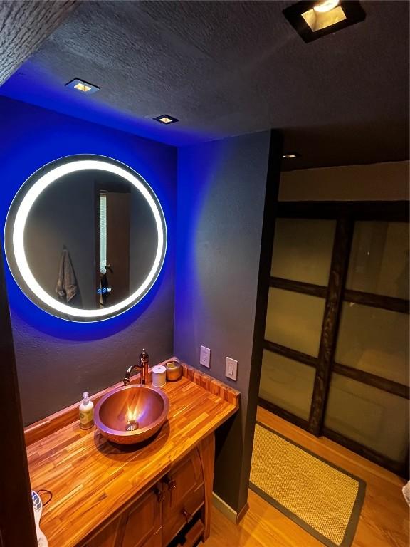 344 Illinois Gulch Rd Unit 201, Breckenridge, CO 80424 - bathroom featuring a textured ceiling, vanity, and wood finished floors