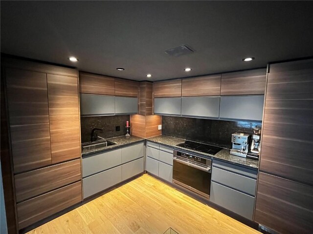 344 Illinois Gulch Rd Unit 201, Breckenridge, CO 80424 - kitchen with stainless steel oven, a sink, black electric cooktop, modern cabinets, and recessed lighting