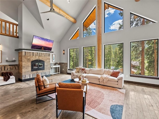 433 97th Cir, Blue River, CO 80424 - living area with high vaulted ceiling, a stone fireplace, healthy amount of natural light, a ceiling fan, and beamed ceiling
