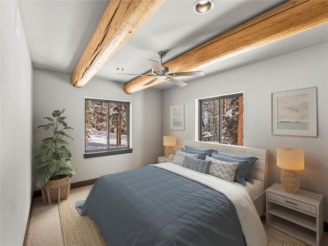 bedroom featuring beamed ceiling, baseboards, carpet floors, and ceiling fan