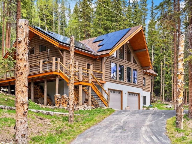 433 97th Cir, Blue River, CO 80424 - view of front facade with faux log siding, a mountain view, and a view of trees