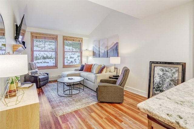 140 Ida Belle Dr Unit 8294, Dillon, CO 80435 - living room with light wood-type flooring, vaulted ceiling, and baseboard heating