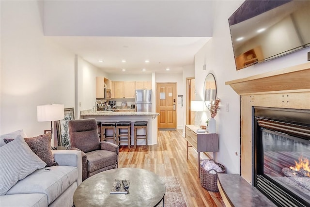 140 Ida Belle Dr Unit 8294, Dillon, CO 80435 - living area with light wood finished floors, a glass covered fireplace, and recessed lighting