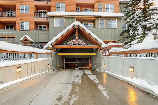140 Ida Belle Dr Unit 8294, Dillon, CO 80435 - snow covered property featuring board and batten siding, an attached garage, and concrete driveway