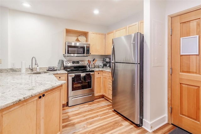 140 Ida Belle Dr Unit 8294, Dillon, CO 80435 - kitchen with stainless steel appliances, light brown cabinetry, light wood finished floors, light stone countertops, and recessed lighting