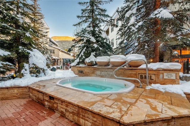 140 Ida Belle Dr Unit 8294, Dillon, CO 80435 - snow covered pool with exterior kitchen and an in-ground hot tub