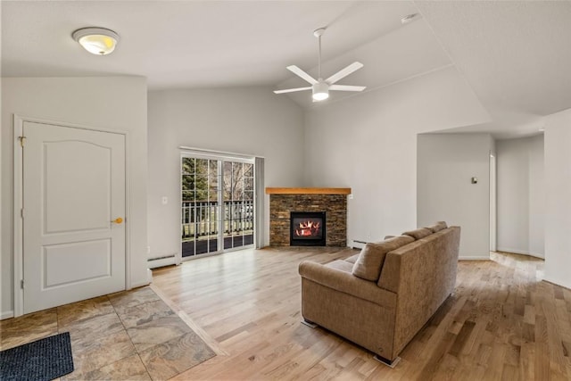 living area featuring a ceiling fan, a baseboard heating unit, high vaulted ceiling, light wood-style floors, and a fireplace