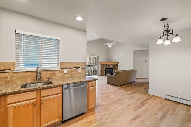 kitchen featuring light wood-style floors, baseboard heating, a sink, and dishwasher