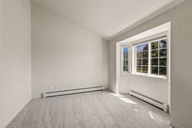 spare room with lofted ceiling, baseboard heating, and carpet floors