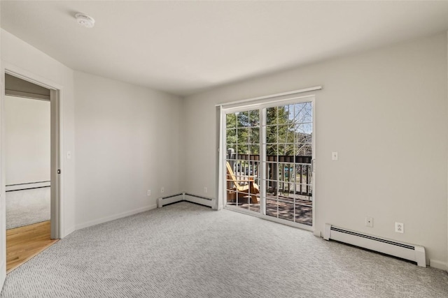 spare room with a baseboard heating unit, a baseboard radiator, carpet flooring, and baseboards
