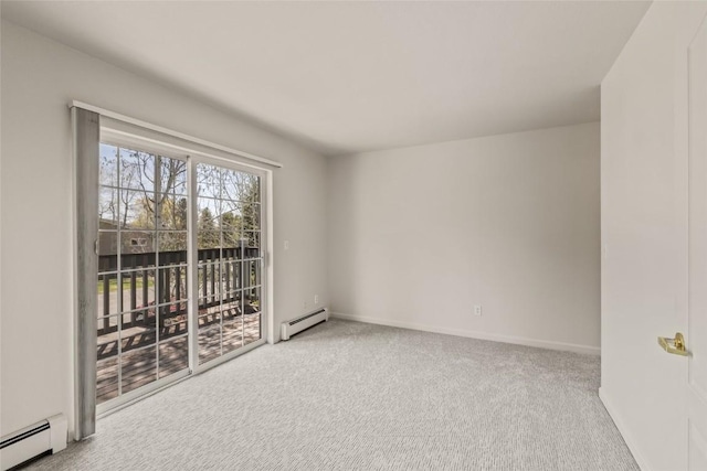 spare room featuring carpet flooring, baseboards, and a baseboard radiator