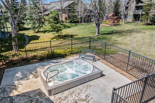 view of patio / terrace with a playground, hot tub deck surround, and fence
