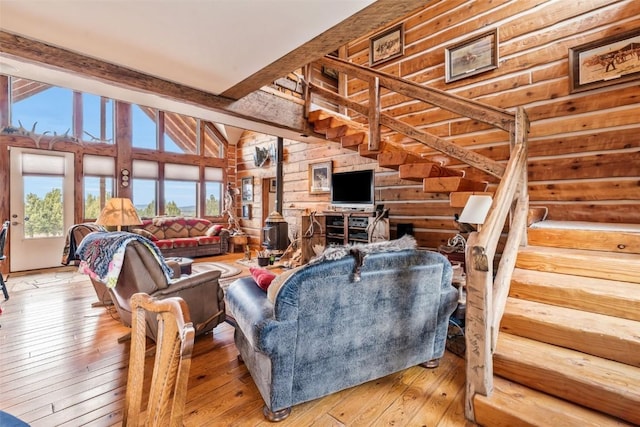 76 County Road 60b, Maybell, CO 81640 - living room featuring light wood-type flooring, wood walls, and stairway