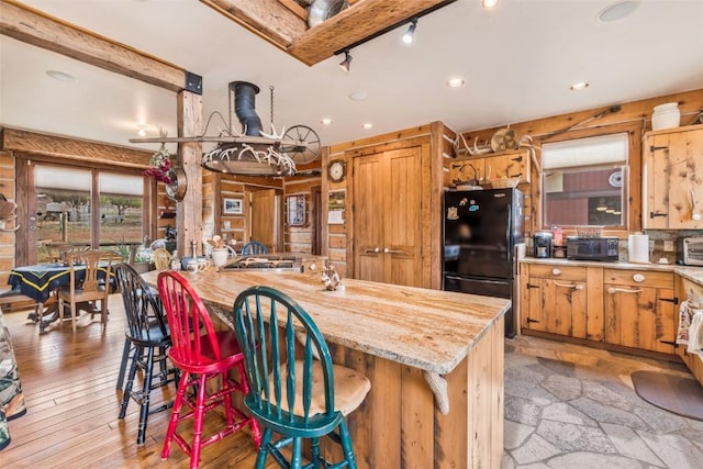 76 County Road 60b, Maybell, CO 81640 - kitchen featuring freestanding refrigerator, recessed lighting, a kitchen bar, a center island, and light wood finished floors