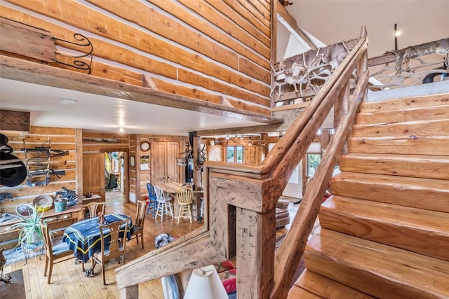 76 County Road 60b, Maybell, CO 81640 - stairs with hardwood / wood-style flooring, rustic walls, and a high ceiling