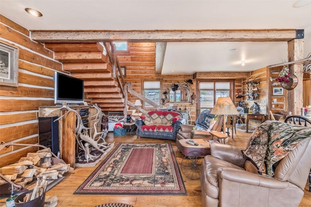 76 County Road 60b, Maybell, CO 81640 - living area with log walls, wood-type flooring, stairway, and beamed ceiling