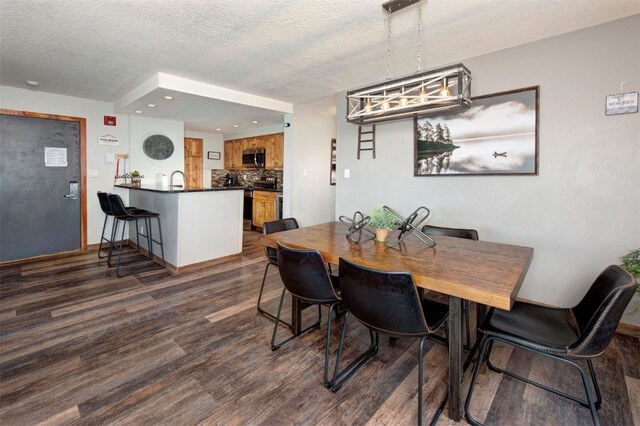 21620 US Highway 6 Unit 2152, Keystone, CO 80435 - dining space with a textured ceiling, dark wood-type flooring, recessed lighting, and a chandelier