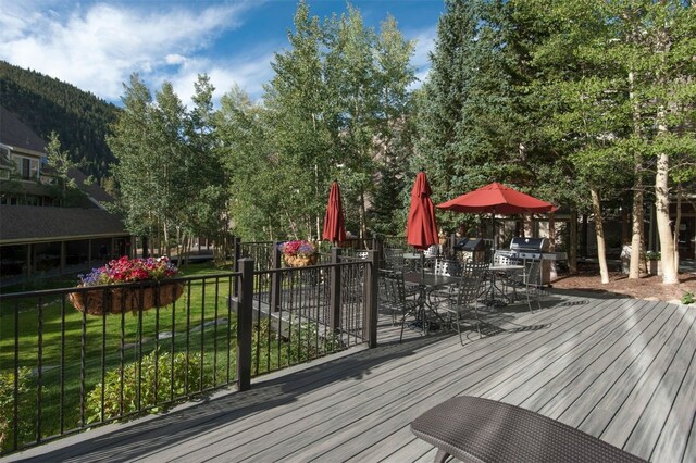 21620 US Highway 6 Unit 2152, Keystone, CO 80435 - deck featuring outdoor dining area, area for grilling, and a yard
