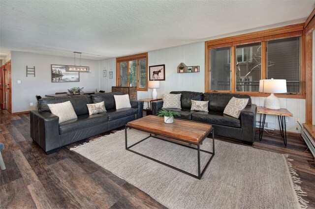 21620 US Highway 6 Unit 2152, Keystone, CO 80435 - living area featuring wood finished floors, baseboards, a textured ceiling, and a chandelier
