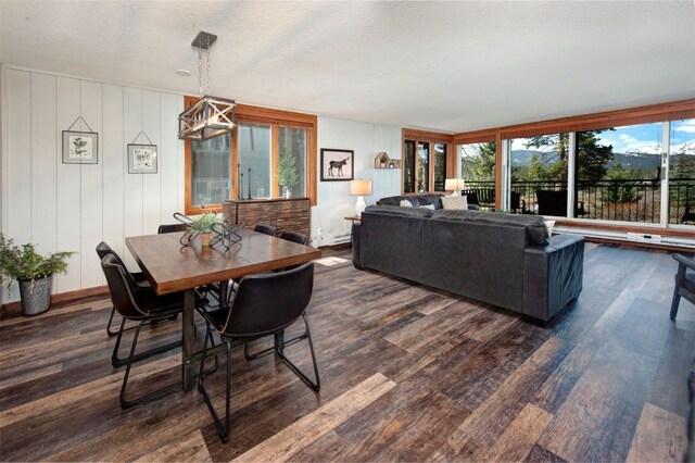 21620 US Highway 6 Unit 2152, Keystone, CO 80435 - dining space with dark wood-type flooring, a chandelier, and a textured ceiling