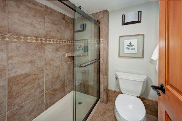 21620 US Highway 6 Unit 2152, Keystone, CO 80435 - bathroom featuring a shower stall, toilet, and tile patterned flooring