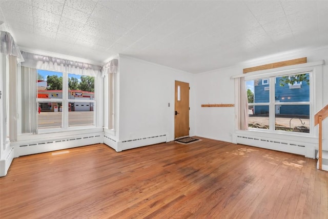 186 E Jefferson Ave, Hayden, CO 81639 - spare room featuring hardwood / wood-style floors, a baseboard radiator, and healthy amount of natural light