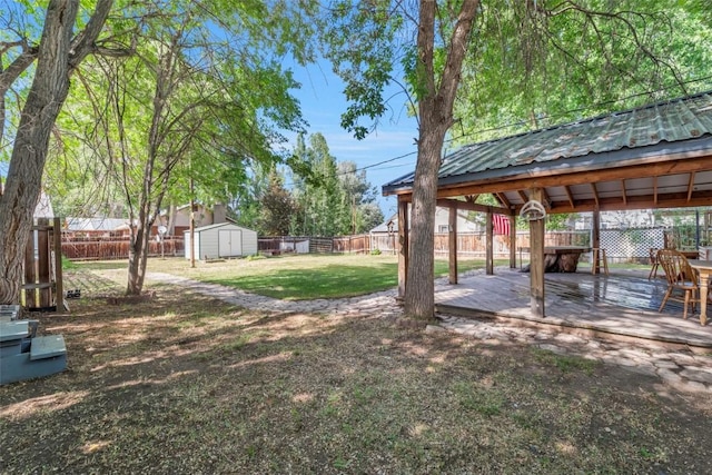 186 E Jefferson Ave, Hayden, CO 81639 - fenced backyard featuring a gazebo, a storage unit, and a wooden deck