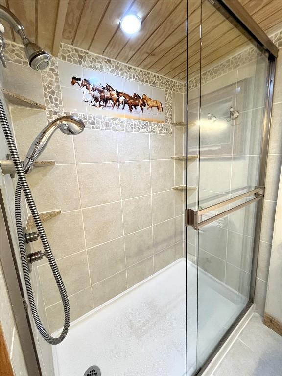 1920 Ski Time Square Dr Unit 208, Steamboat Springs, CO 80487 - bathroom featuring a shower stall and wooden ceiling