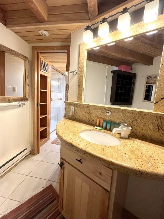 1920 Ski Time Square Dr Unit 208, Steamboat Springs, CO 80487 - bathroom featuring a wooden ceiling with exposed beams, vanity, tile patterned floors, and a baseboard radiator
