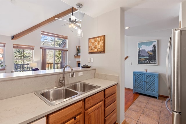 700 Lakepoint Dr Unit A10, Frisco, CO 80443 - kitchen featuring ceiling fan, a sink, light countertops, freestanding refrigerator, and vaulted ceiling with beams