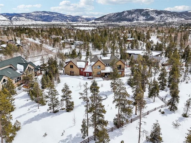 snowy aerial view with a residential view and a mountain view