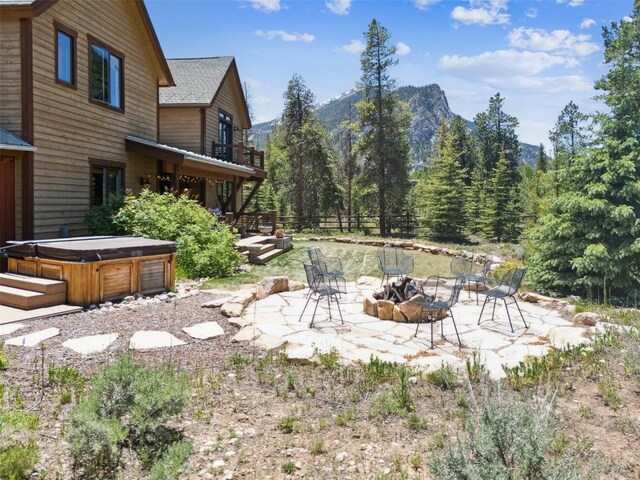 223 County Road 1041, Frisco, CO 80443 - view of yard featuring a fire pit, a hot tub, a patio, and a mountain view