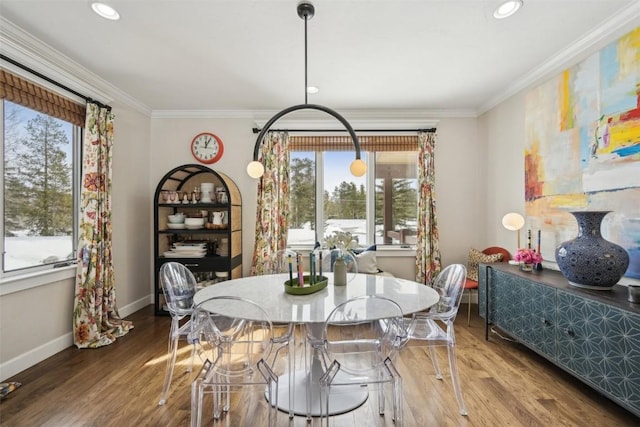 dining area with crown molding, baseboards, and plenty of natural light