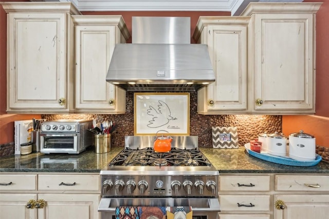 kitchen featuring wall chimney range hood, high end range, a toaster, backsplash, and ornamental molding