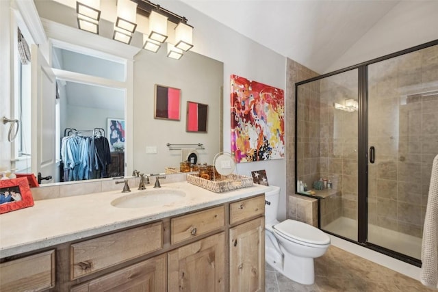 bathroom featuring tile patterned flooring, a stall shower, vanity, toilet, and lofted ceiling