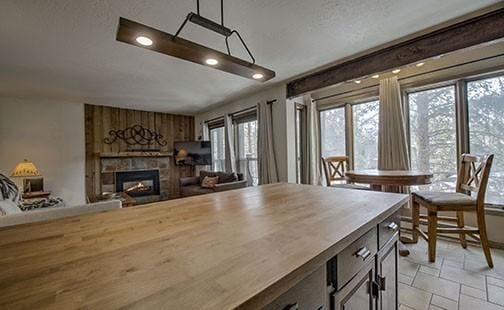 820 Columbine Rd Unit 10, Breckenridge, CO 80424 - dining area featuring stone tile floors, recessed lighting, a textured ceiling, and a glass covered fireplace