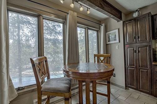 820 Columbine Rd Unit 10, Breckenridge, CO 80424 - dining space featuring beam ceiling and baseboards
