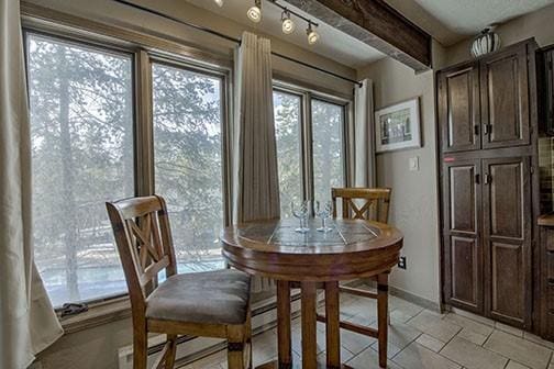 820 Columbine Rd Unit 10, Breckenridge, CO 80424 - dining room featuring beamed ceiling and baseboards