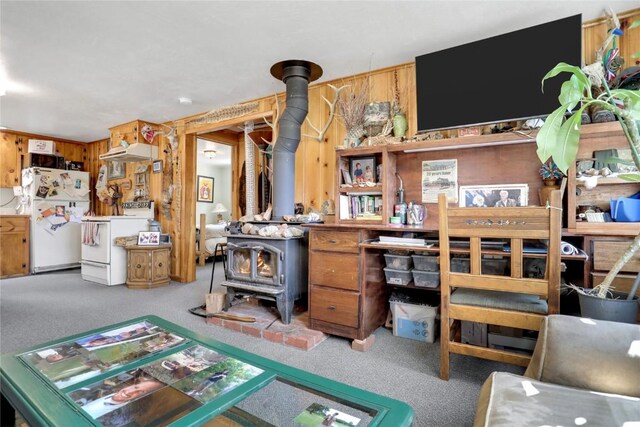 823 Gcr 8411, Tabernash, CO 80478 - living area featuring a wood stove, carpet, and wood walls