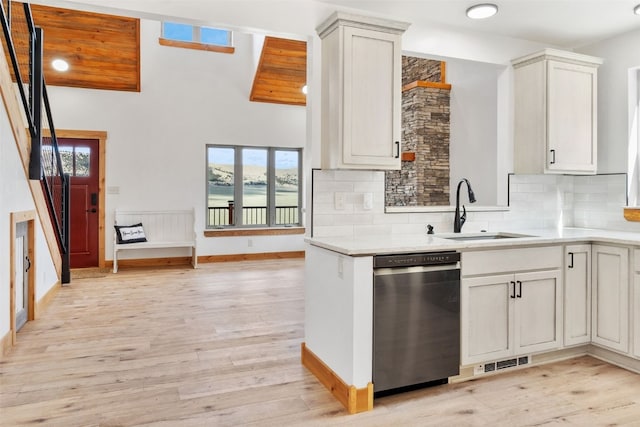 3415 Redhill Rd, Fairplay, CO 80440 - kitchen featuring a sink, light countertops, stainless steel dishwasher, tasteful backsplash, and light wood finished floors