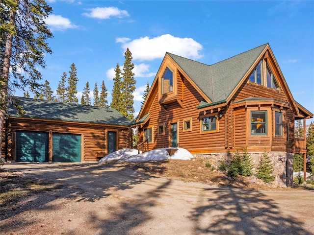 333 Camron Ln, Breckenridge, CO 80424 - cabin with log siding, roof with shingles, driveway, and a garage