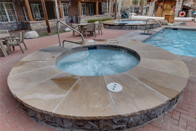91 River Run Rd Unit 8122, Keystone, CO 80435 - community pool featuring a hot tub, a patio area, and outdoor dining space