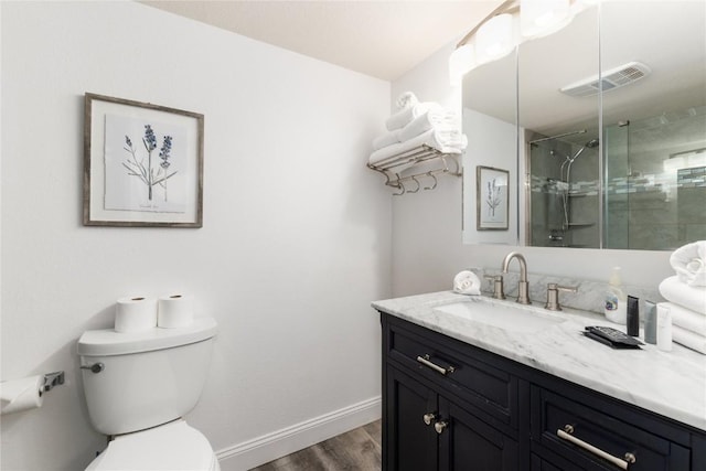 72 Corinthian Cir Unit 102, Dillon, CO 80435 - full bath featuring vanity, wood finished floors, toilet, a shower stall, and baseboards