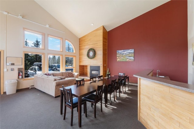 72 Corinthian Cir Unit 102, Dillon, CO 80435 - dining area featuring high vaulted ceiling, a fireplace, dark carpet, and a baseboard radiator