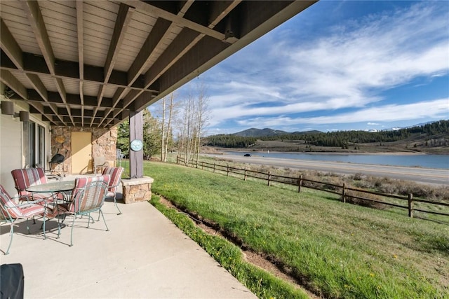 72 Corinthian Cir Unit 102, Dillon, CO 80435 - view of patio featuring outdoor dining area and a water and mountain view