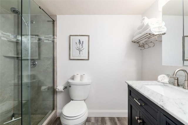 72 Corinthian Cir Unit 102, Dillon, CO 80435 - full bathroom with vanity, toilet, a stall shower, and wood finished floors